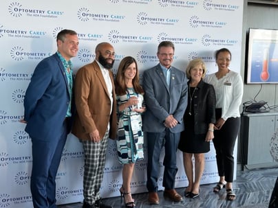 Dr. Glover receiving an award on behalf of MyEyeDr. for the organization’s contribution and commitment to the Optometry Cares AOA Foundation.

